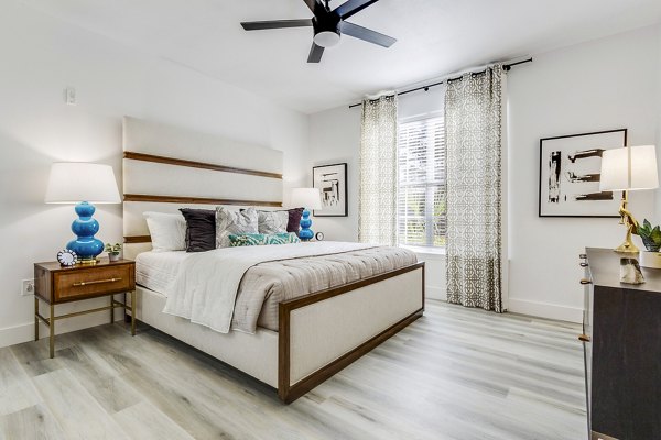Spacious bedroom with elegant furnishings at The Reserve at Wescott Apartments in Greystar community