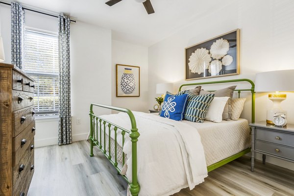 Master bedroom with modern decor at The Reserve at Wescott Apartments