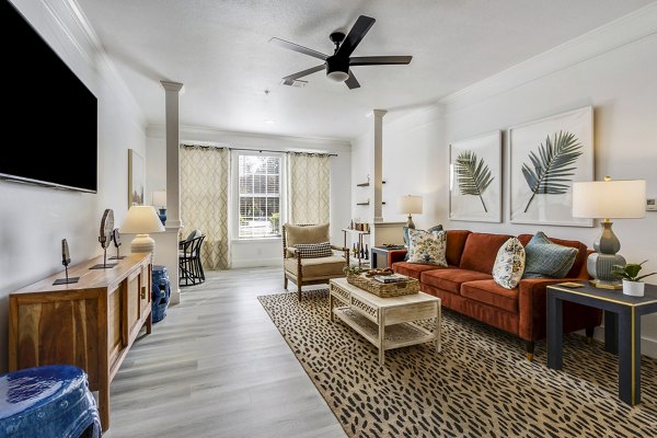 Spacious living room with modern decor and large windows at The Reserve at Wescott Apartments