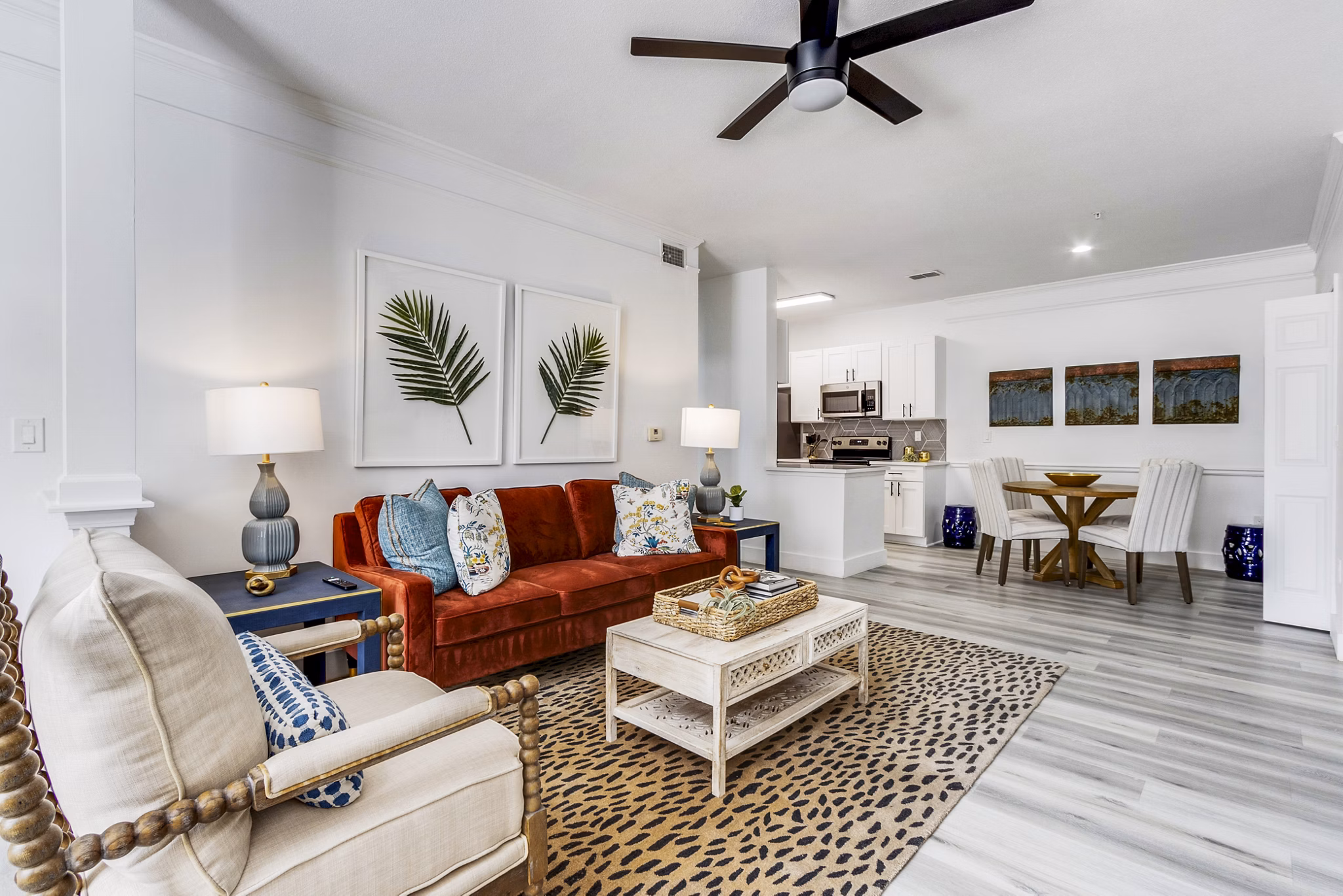 Modern living room featuring elegant decor and large windows at The Reserve at Wescott Apartments