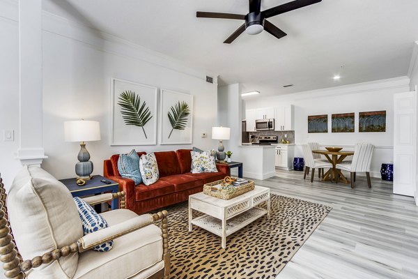 Modern living room featuring elegant decor and large windows at The Reserve at Wescott Apartments