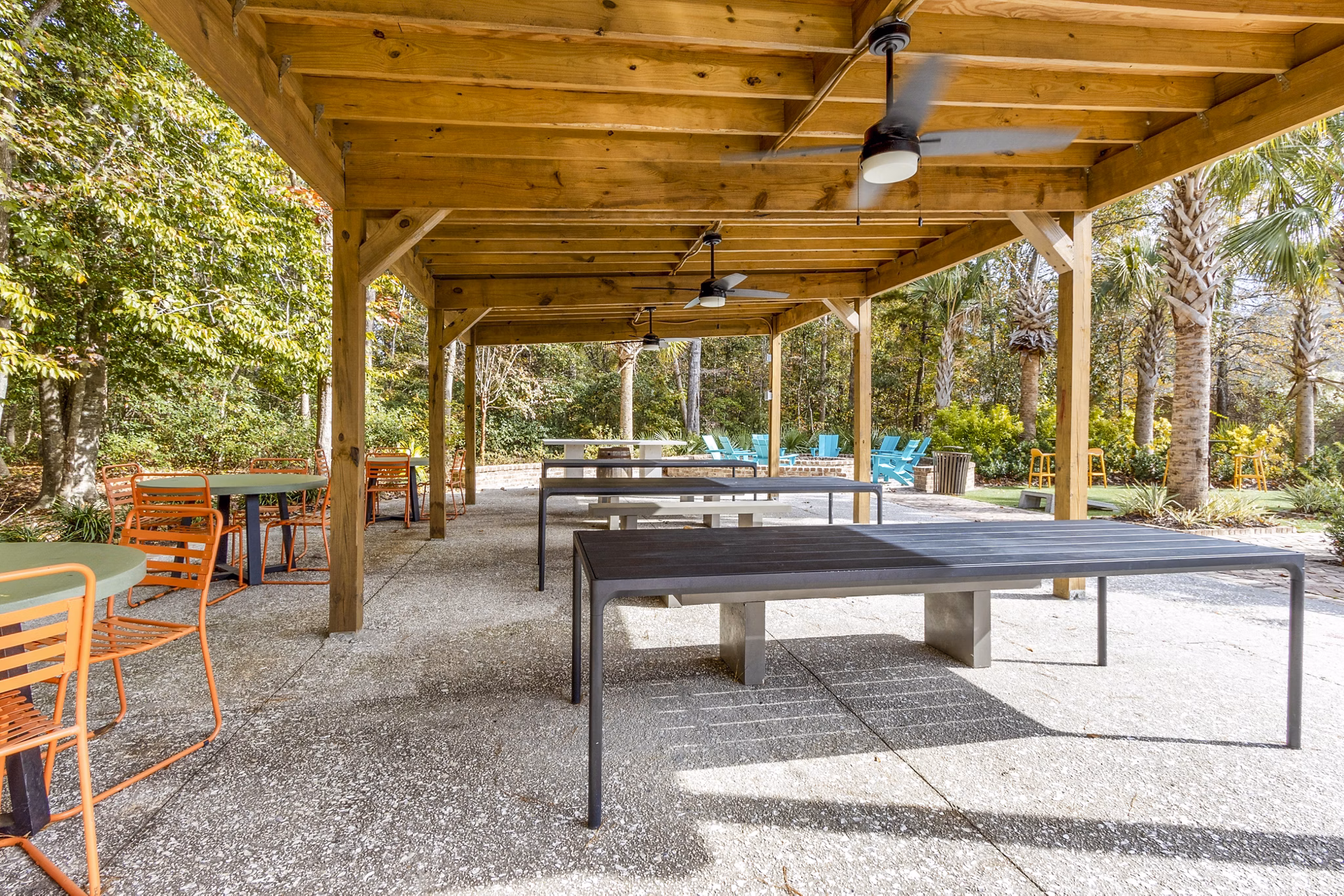 Outdoor grill area with patio seating at The Reserve at Wescott Apartments