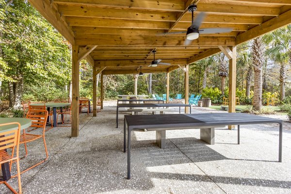 Outdoor grill area with patio seating at The Reserve at Wescott Apartments