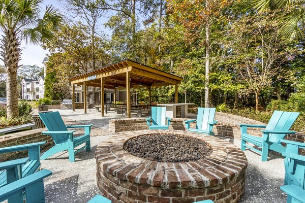 Outdoor fire pit and patio area at The Reserve at Wescott Apartments offering a cozy ambiance for residents to relax and socialize