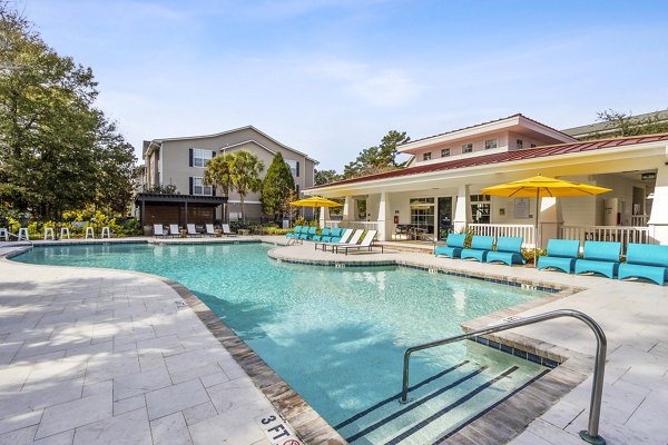 Resort-style pool with lounge chairs at The Reserve at Wescott Apartments, luxury living by Greystar