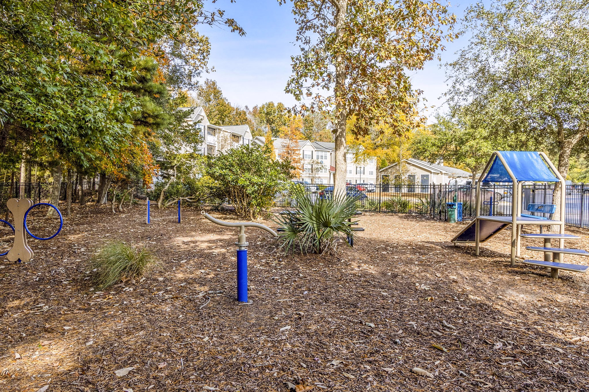 Playground with colorful slides and climbing structures at The Reserve at Wescott Apartments, perfect for family fun and outdoor play