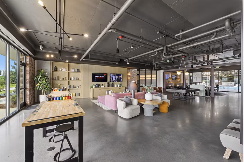 Clubhouse at The Boulevard: Modern meeting space with comfortable seating in Grant Park apartments, ideal for social gatherings
