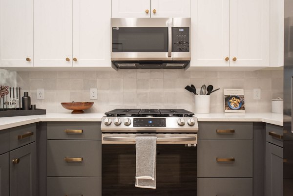 Modern kitchen with stainless steel appliances in The Boulevard at Grant Park Apartments