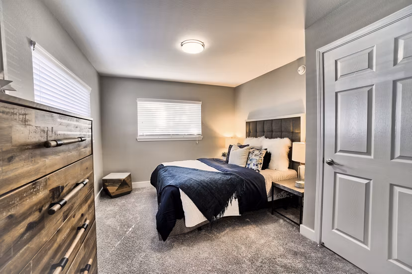 Cozy bedroom with modern decor at The Arden Apartments, by Greystar