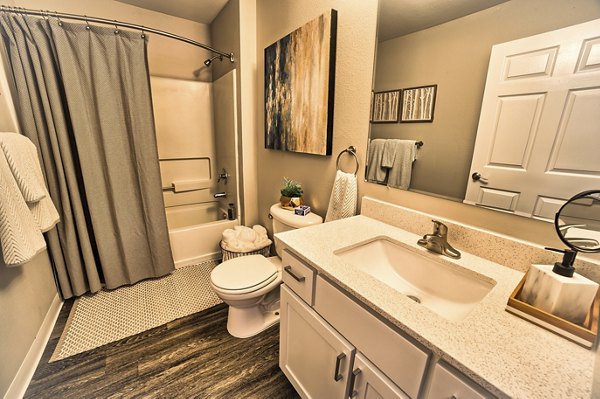 Luxurious bathroom featuring marble countertops and modern fixtures at The Arden Apartments