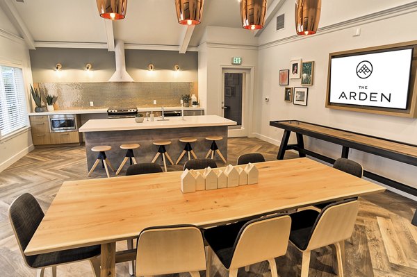 Modern clubhouse at The Arden Apartments with luxury seating and entertainment options Enjoy premium amenities in a vibrant Greystar community