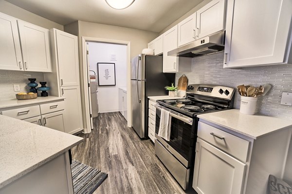 Modern kitchen with stainless steel appliances in The Arden Apartments