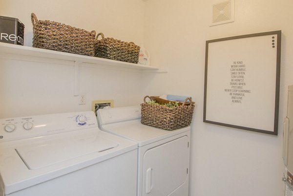 Laundry room with modern equipment and ample natural light at The Arden Apartments