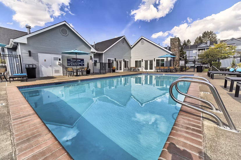Outdoor swimming pool at The Arden Apartments with modern design and ample lounging space