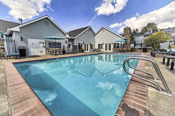 Outdoor swimming pool at The Arden Apartments with modern design and ample lounging space