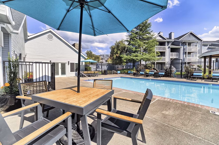 Resort-style pool with lounge chairs at The Arden Apartments