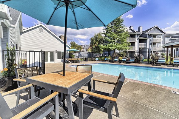 Resort-style pool with lounge chairs at The Arden Apartments
