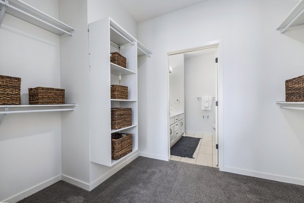 Bedroom closet with built-in shelving and ample storage at Avidor Omaha Apartments, a luxury senior living community