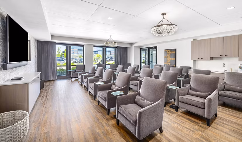 Clubhouse theater with plush seating and large screen at Avidor Omaha Apartments