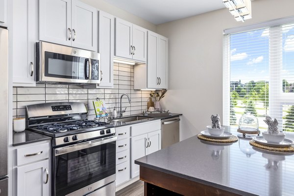 Modern kitchen with stainless steel appliances at Avidor Omaha Apartments offering luxury living
