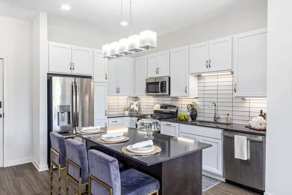 Modern kitchen featuring stainless steel appliances and granite countertops at Avidor Omaha Apartments