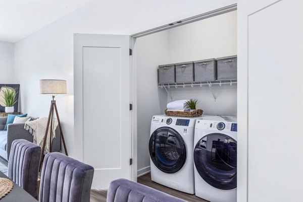 Laundry room featuring modern appliances in Avidor Omaha Apartments