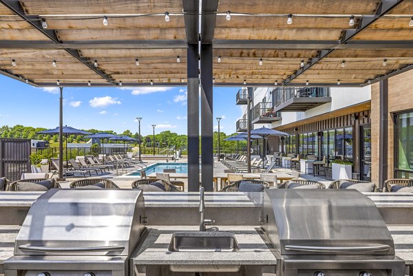 Outdoor grill area with modern patio at Avidor Omaha Apartments