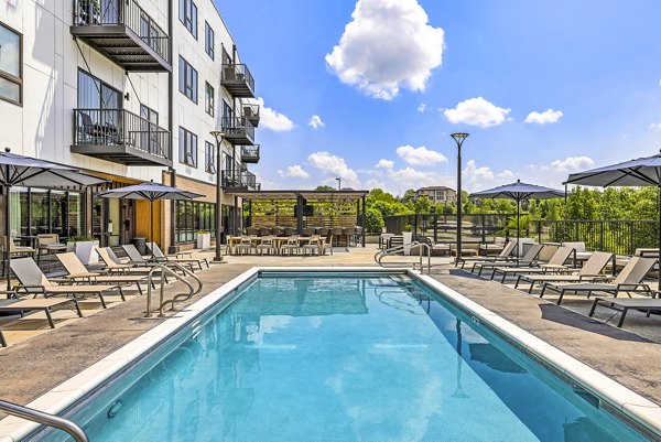 Elegant pool area with sun loungers at Avidor Omaha Apartments, perfect for relaxation and leisure