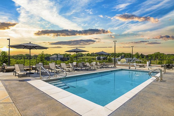 Refreshing outdoor pool with stylish seating at Avidor Omaha Apartments, offering luxury leisure in a vibrant community setting