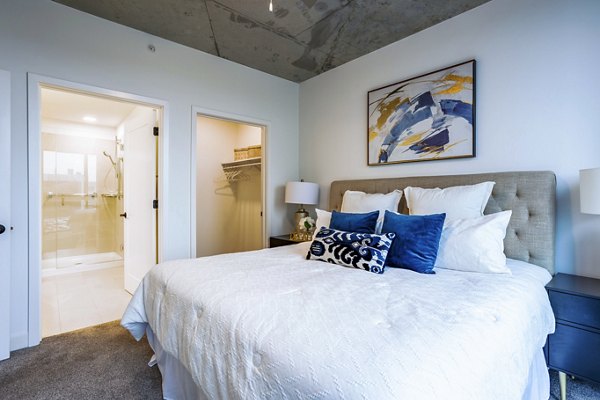 Cozy bedroom with modern decor at Avidor Evanston Apartments offering comfort and style