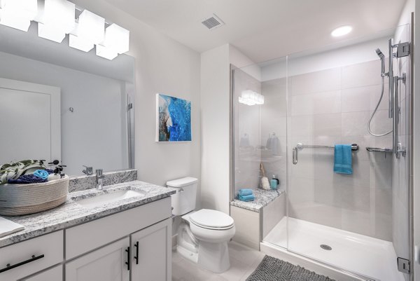 Avidor Evanston Apartments: Modern bathroom featuring sleek fixtures and ample lighting