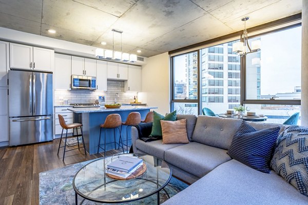 Cozy living room with modern furnishings and natural light in Avidor Evanston Apartments