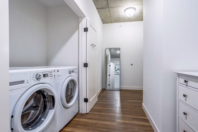 Laundry room with modern appliances at Avidor Evanston Apartments