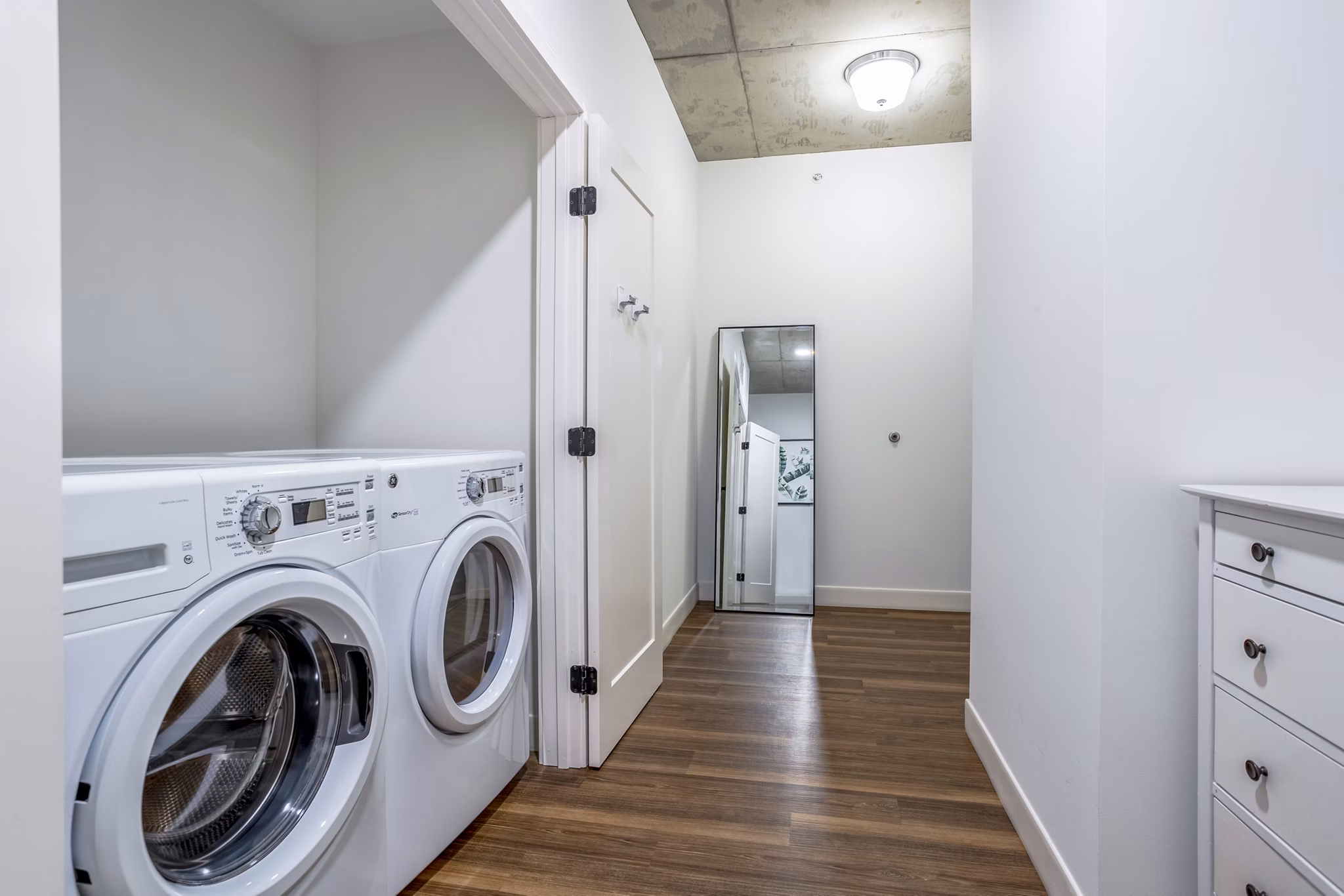 Laundry room with modern appliances at Avidor Evanston Apartments