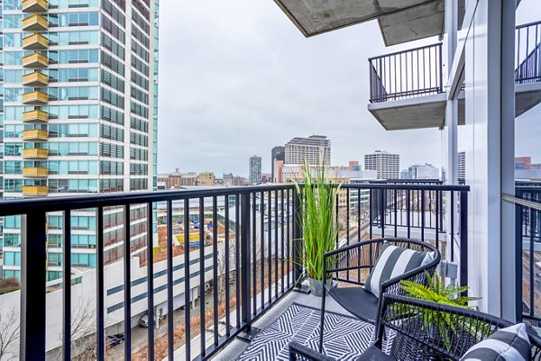 Modern patio/balcony space with seating at Avidor Evanston Apartments, offering luxury outdoor living in a Greystar community