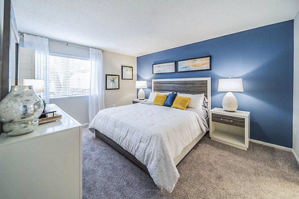 Cozy bedroom with modern decor and ample natural light at Bay Cove Apartments