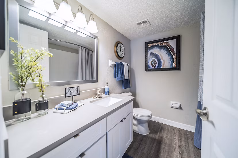 Elegant bathroom featuring marble countertops and contemporary fixtures at Bay Cove Apartments in this luxury living space