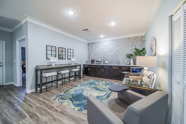 Clubhouse with modern decor and seating areas at Bay Cove Apartments