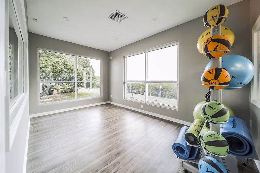 Yoga studio featuring calming decor and natural light at Bay Cove Apartments