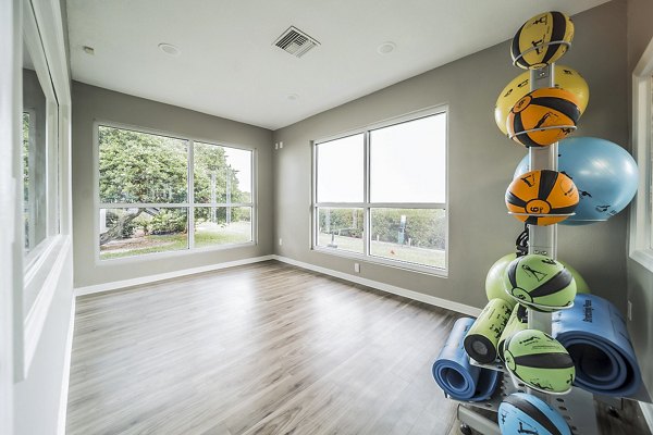 Yoga studio featuring calming decor and natural light at Bay Cove Apartments