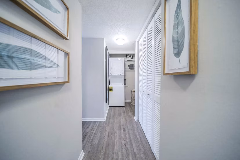 Well-lit hallway and laundry room at Bay Cove Apartments