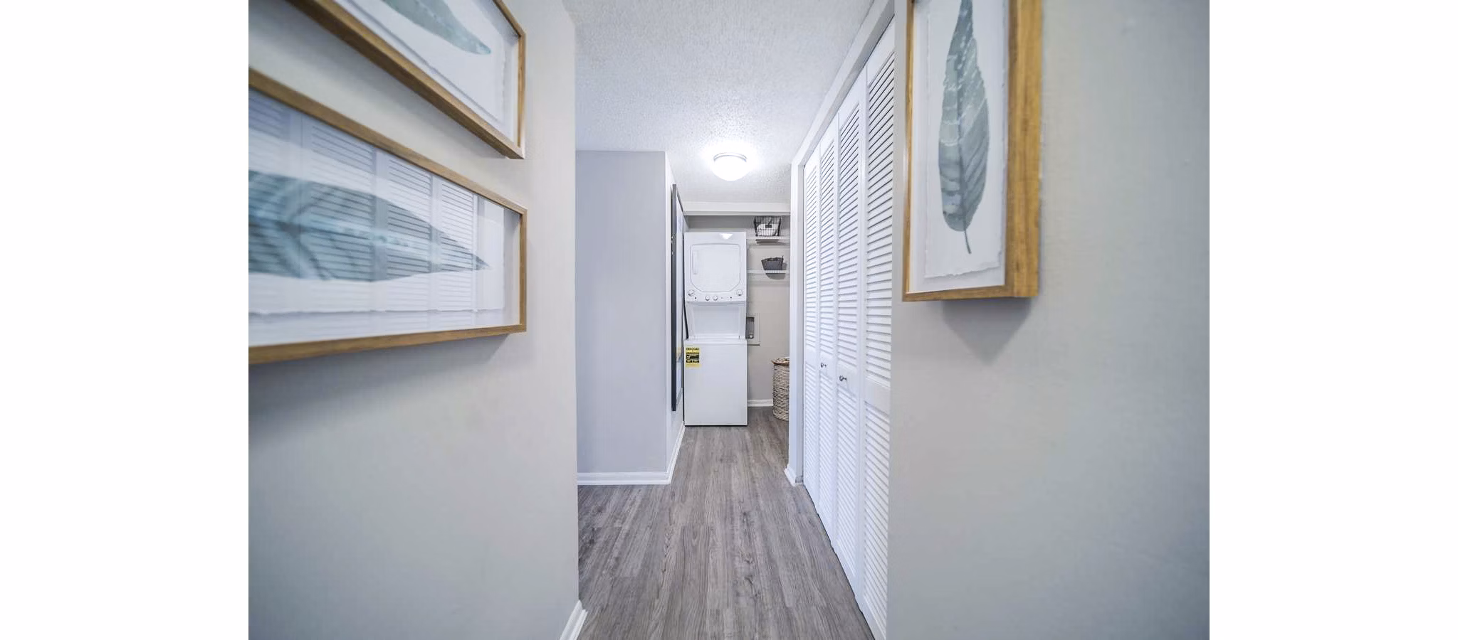 Well-lit hallway and laundry room at Bay Cove Apartments