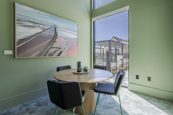 Conference room with large table and modern chairs at Novel Daybreak Apartments, ideal for meetings and events