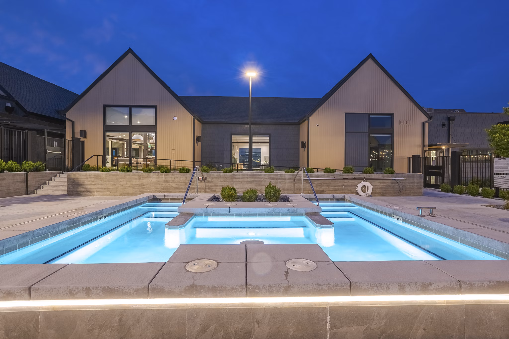 Modern pool with sun loungers at Novel Daybreak Apartments offering a relaxing recreational space