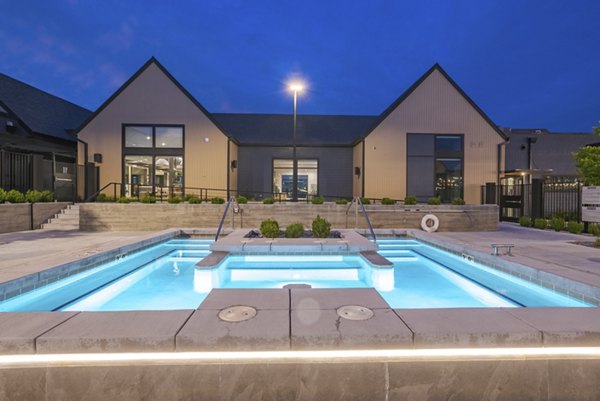 Modern pool with sun loungers at Novel Daybreak Apartments offering a relaxing recreational space