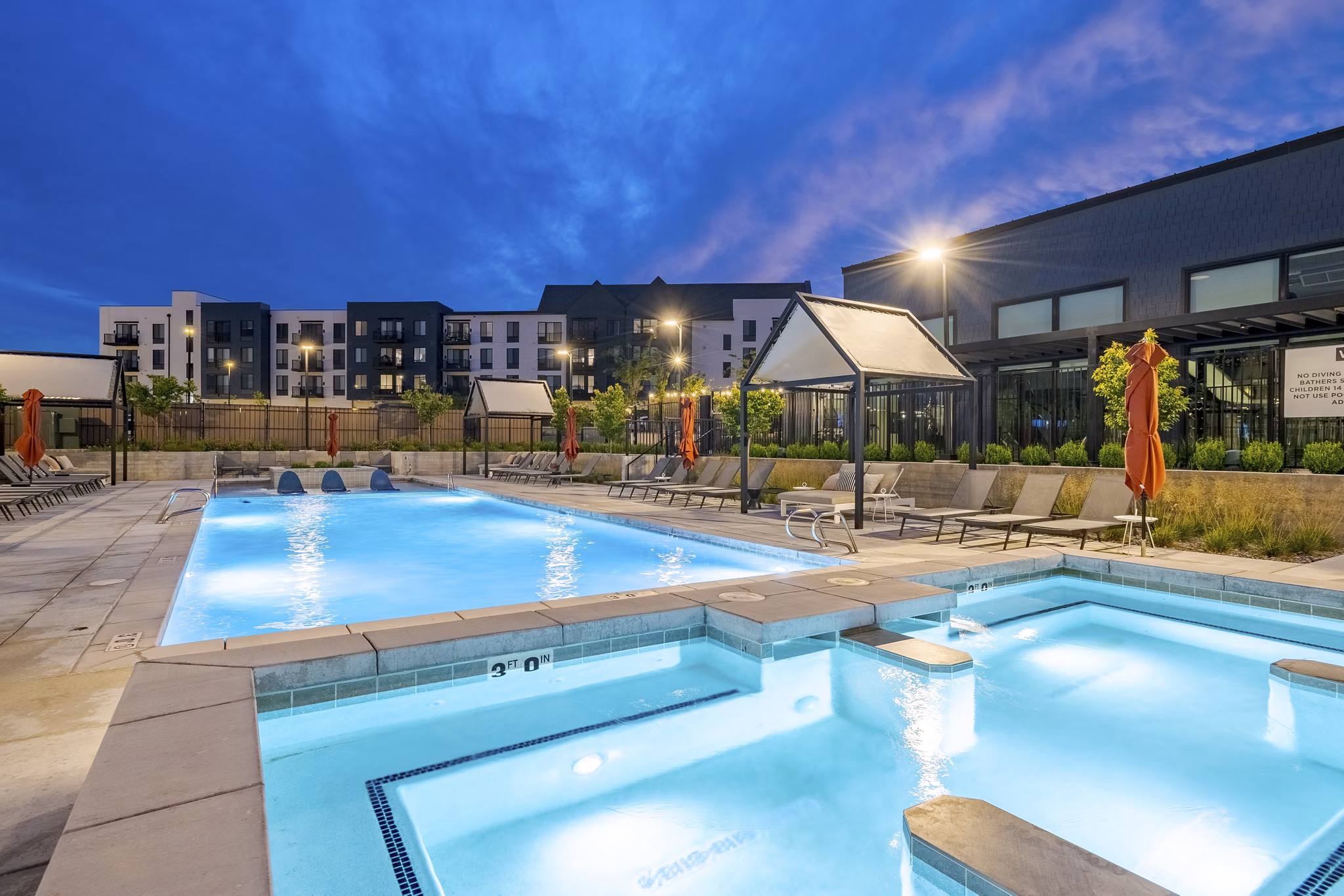Luxurious outdoor pool with loungers at Novel Daybreak Apartments, a premier Greystar community