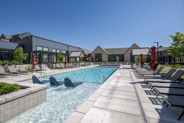 Scenic pool with lounge chairs at Novel Daybreak Apartments