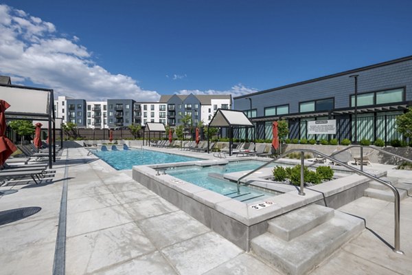 Inviting pool with lounge chairs at Novel Daybreak Apartments, perfect for relaxation and recreation