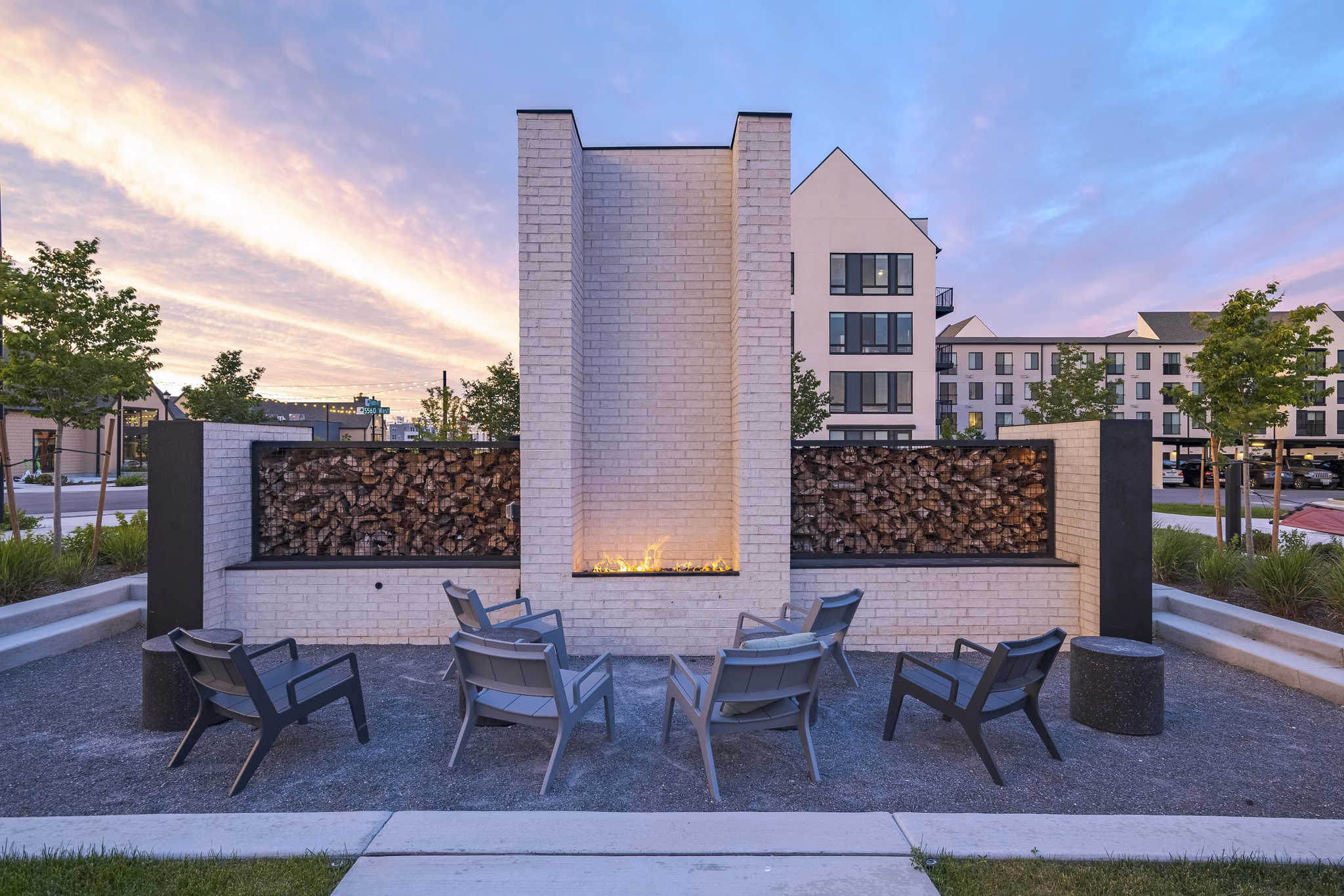 Modern fire pit area with cozy seating at Novel Daybreak Apartments, creating a perfect outdoor relaxation space