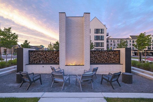 Modern fire pit area with cozy seating at Novel Daybreak Apartments, creating a perfect outdoor relaxation space